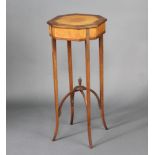 A Georgian octagonal crossbanded satinwood occasional table with outswept supports and X framed