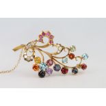 A high carat multi gem set spray brooch 57mm and a pair of matching ear studs 18mm, contained in