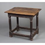 An 18th Century oak side table, the top formed from 2 planks raised on turned and block supports