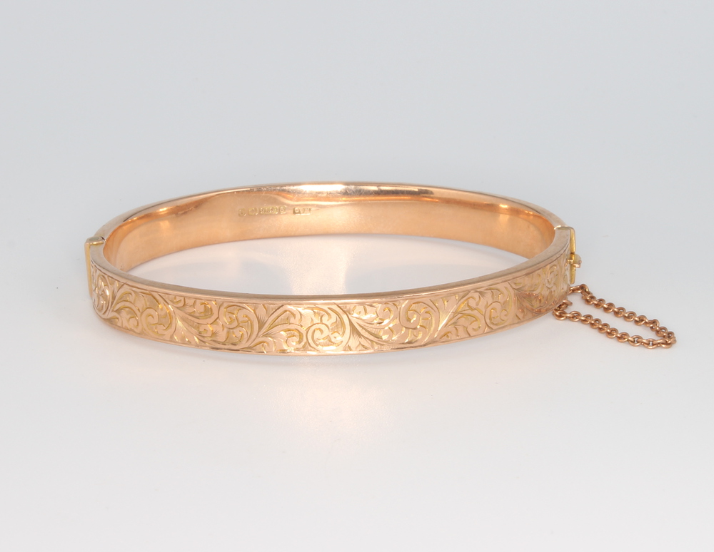 A 9ct yellow gold engraved bangle 8.8 grams