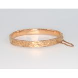 A 9ct yellow gold engraved bangle 8.8 grams