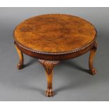 A circular Queen Anne style figured walnut occasional table with quarter veneered top, gadrooned