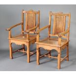 A pair of Oriental hardwood and figured walnut slat back open arm chairs with solid seats, raised on