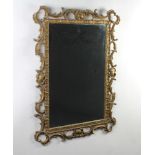 An Italian style rectangular plate mirror contained in a decorative gilt frame 99cm h x 74cm w
