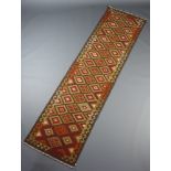 A red, brown and tan Maimana kilim runner with all over geometric design 295cm x 80cm