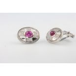 A pair of 18ct white gold cabochon cut ruby and diamond oval cufflinks 16.4 grams