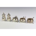 A silver 5 piece condiment set Chester 1927 comprising pair of peppers, pair of circular salts (no