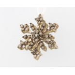 A 9ct yellow gold diamond set snowflake pendant, 2.7 grams