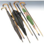 An ebony walking cane with silver terminal, walking stick with 9ct gold band, 2 canes with silver