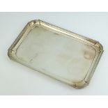 A rectangular silver dressing table tray with bracketed border, marks rubbed, 414 grams