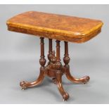 A Victorian burr walnut quarter veneered rectangular card table, raised on 4 columns with tripod