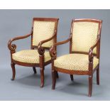 A matched pair of Empire style mahogany open armchairs, the seats and backs upholstered in gold