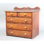 A cedar wood apprentice chest with raised back, fitted 2 short and 3 long drawers with brass