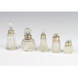 A globular cut glass scent bottle with silver collar 5 cm and 4 others