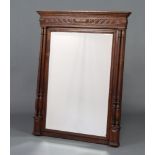 A 19th Century French rectangular bevelled plate mirror contained in a carved oak frame with moulded
