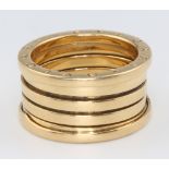 An 18ct yellow gold Bulgari style expanding wedding band, size R, 13 grams