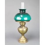 A brassed oil lamp with green glass shade and clear glass chimney 50cm h