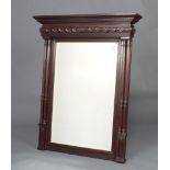 A 19th Century rectangular bevelled plate mirror contained in a carved oak frame with fluted columns