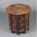 An Eastern octagonal carved and pierced hardwood table raised on a hinged folding stand 47cm h x