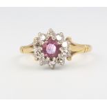 An 18ct yellow gold ruby and diamond cluster ring, size N 1/2, 4.3 grams