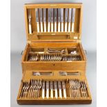 A part canteen of Mappin and Webb Old English rat tail pattern silver plated flatware in an oak