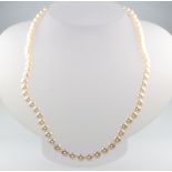 A strand of cultured pearls with silver clasp, 44cm