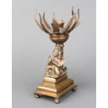An Eastern bronze incense burner with flower head decoration, the base with a figure of a seated