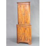 A Georgian style mahogany corner cocktail cabinet, the upper section with moulded and dentil
