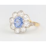 A yellow gold sapphire and diamond cluster ring, the centre stone approx. 1.3ct surrounded by