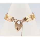 A 9ct yellow gold gate bracelet with heart padlock, 14 grams