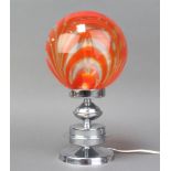 A 1960's glass and chrome table lamp with orange and clear glass striped shade, raised on a chrome