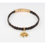 A gold mounted bracelet with a yellow gold elephant charm