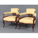 A pair of Edwardian show frame mahogany tub back arm chairs upholstered in yellow material, raised