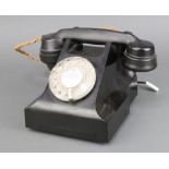 A black Bakelite dial telephone, the base marked AEP