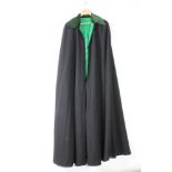 A long black opera coat/mantle with green velvet collar and green silk lining 5 small holes by the