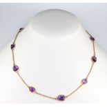 A yellow gold amethyst set necklace 44cm