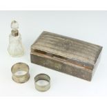 A rectangular silver cigarette box with hinged lid, cut glass dressing table bottle with silver