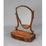 A 19th Century Sheraton style shield shaped dressing table mirror contained in a mahogany swing