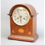 An Edwardian striking bracket clock with silvered dial and Roman numerals contained in an inlaid