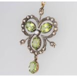 An Edwardian style peridot, seed pearl and diamond pendant on a 9ct chain