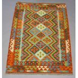 A green, turquoise and blue ground Chobi Kilim rug, the central field with all over geometric