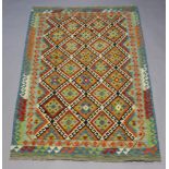 An orange, green and turquoise ground Chobi Kilim rug with 22 diamonds to the centre within a 2