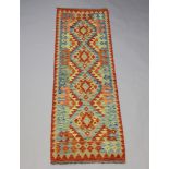 A orange, blue and turquoise ground Chobi Kilim runner 197cm x 60cm