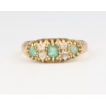 An 18ct yellow gold 3 stone emerald and diamond ring, 3.5 grams, size N