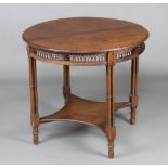 An Edwardian Chippendale style circular mahogany occasional table with pierced apron, raised on