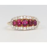 A yellow gold ruby and diamond dress ring, size NThe rubies are scratched