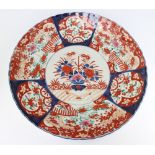 A 19th Century Japanese Imari charger decorated a basket of flowers and with panel decoration, lobed