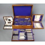 An Edwardian mahogany canteen containing a quantity of plated cutlery and 2 cased plated sets