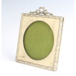 An Edwardian square embossed silver easel photograph frame with garland decoration Chester 1905 14cm