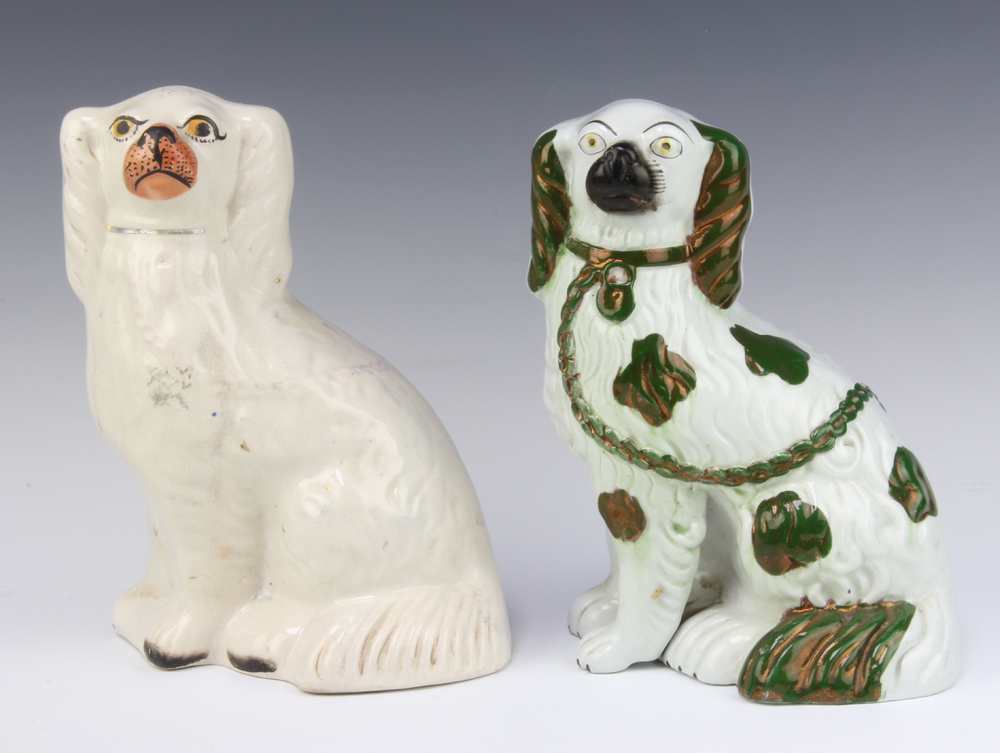 A 19th Century Staffordshire figure of a seated spaniel with separately moulded front leg 23cm and 1